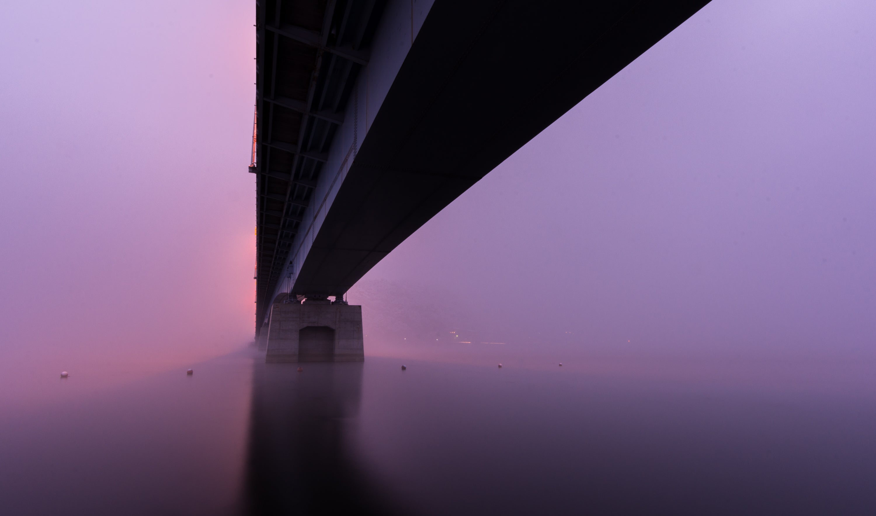 files/a-bridge-sitting-in-thick-pink-and-purple-fog.jpg